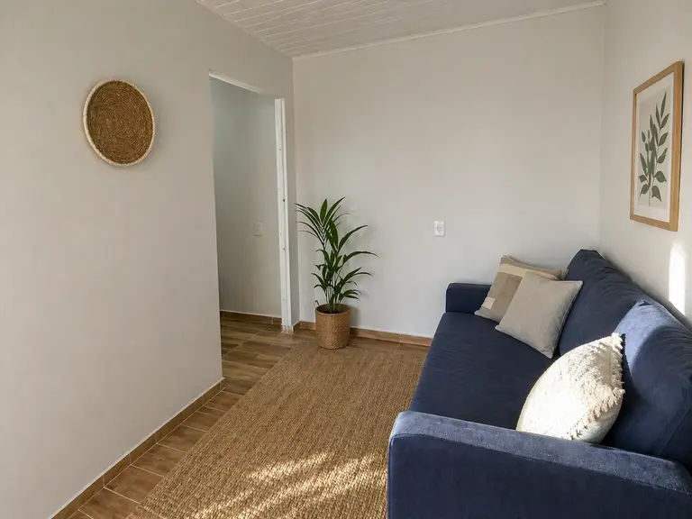 Sala do apartamento térreo mobiliado em Cascavel PR com sofá e ambiente preparado para hóspedes.